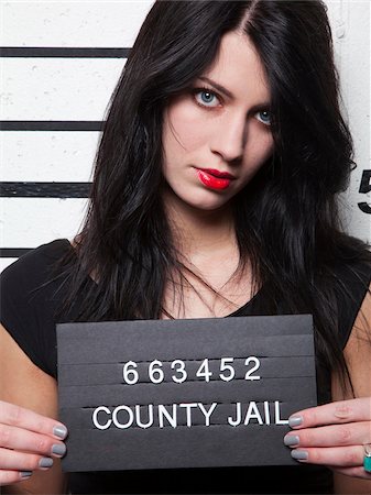 prisoners - Studio mugshot of young woman Stock Photo - Premium Royalty-Free, Code: 640-05760903