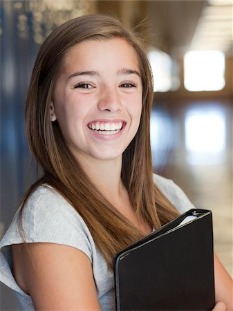 smiling teenage school girls - USA, Utah, Spanish Fork, Portrait of school girl (16-17) holding file in corridor Stock Photo - Premium Royalty-Free, Code: 640-05761055