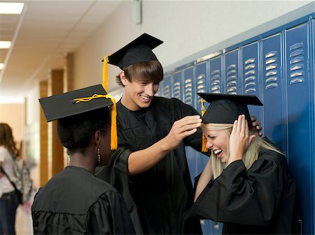 students graduating college - USA, Utah, Spanish Fork, Three graduate students preparing for ceremony Stock Photo - Premium Royalty-Free, Code: 640-05761059