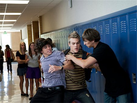 school boys fighting images - USA, Utah, Spanish Fork, Three boys (16-17) fighting in school corridor Stock Photo - Premium Royalty-Free, Code: 640-05761062