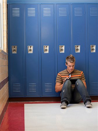 USA, Utah, Spanish Fork, School boy (16-17) using digital tablet by lockers Stock Photo - Premium Royalty-Free, Code: 640-05761087