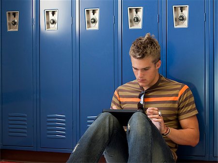 USA, Utah, Spanish Fork, School boy (16-17) using digital tablet by lockers Stock Photo - Premium Royalty-Free, Code: 640-05761088