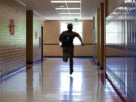 running in corridors - USA, Utah, Spanish Fork, School boy (16-17) running in corridor Stock Photo - Premium Royalty-Free, Code: 640-05761080