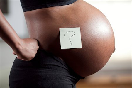question mark - Profile of pregnant young woman's abdomen Stock Photo - Premium Royalty-Free, Code: 640-05761098