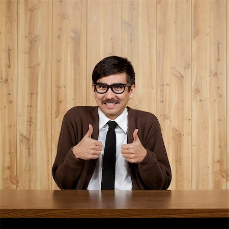 Portrait of businessman giving thumbs up Stock Photo - Premium Royalty-Free, Code: 640-05761171