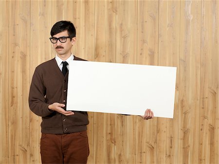 funny spectacles pictures - Businessman holding blank placard in office Stock Photo - Premium Royalty-Free, Code: 640-05761197