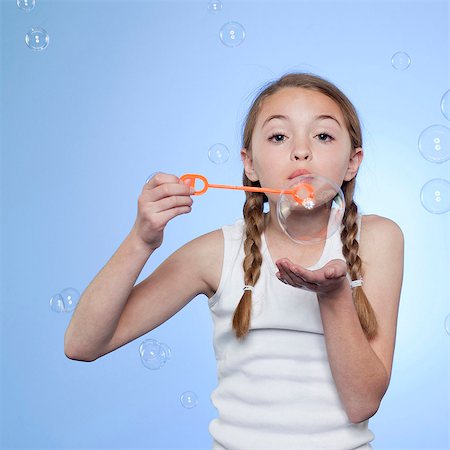 pucker - Studio portrait of girl (10-11) blowing bubbles Foto de stock - Sin royalties Premium, Código: 640-05761267