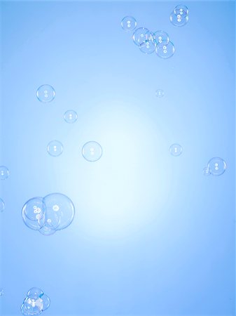 Studio shot of bubbles against blue background Stock Photo - Premium Royalty-Free, Code: 640-05761268