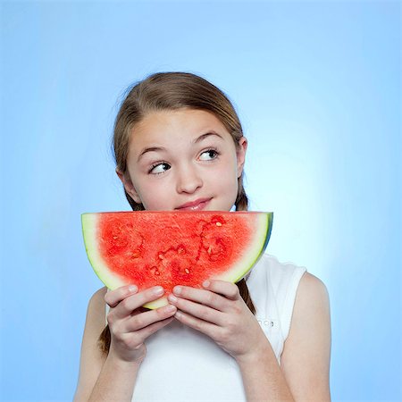 simsearch:640-05761270,k - Studio shot of girl (10-11) holding slice of watermelon Stock Photo - Premium Royalty-Free, Code: 640-05761262