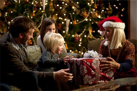 regalo de navidad - USA, Utah, Cedar Hills, Three generation family with girls (2-3, 8-9) opening Christmas presents Foto de stock - Sin royalties Premium, Código: 640-05761309