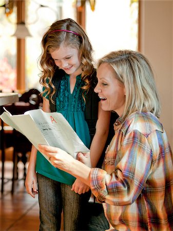 exam success - USA, Utah, Cedar Hills, Girl (8-9) showing examination results with grade A to mother Stock Photo - Premium Royalty-Free, Code: 640-05761323