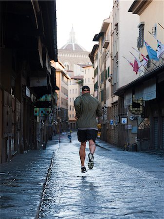 Italy, Florence, Man jogging in city Stock Photo - Premium Royalty-Free, Code: 640-06049836