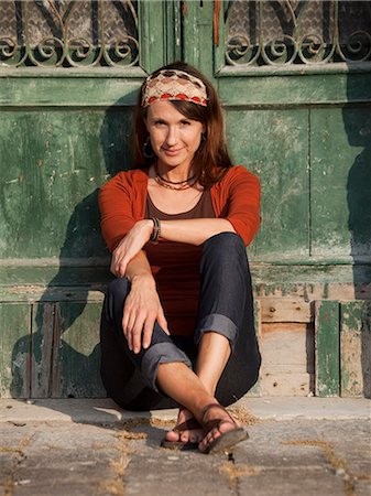 sandals mature woman - Italy, Venice, Portrait of woman sitting by wooden door in old town Stock Photo - Premium Royalty-Free, Code: 640-06049843