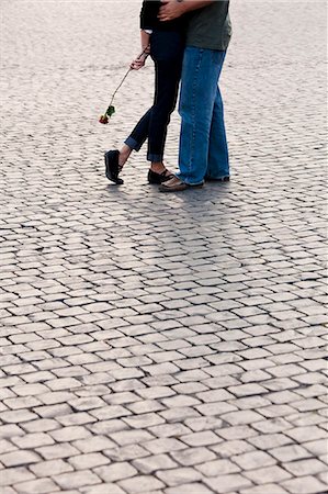 Italy, Rome, Vatican City, Close up of legs of couple with rose standing on cobblestone Stock Photo - Premium Royalty-Free, Code: 640-06050025
