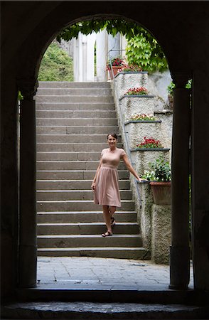 Italy, Ravello, Portrait of woman in dress standing on stairs Stock Photo - Premium Royalty-Free, Code: 640-06050028