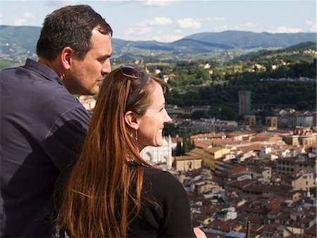 Italy, Florence, Smiling couple looking at townscape Stock Photo - Premium Royalty-Free, Code: 640-06050188