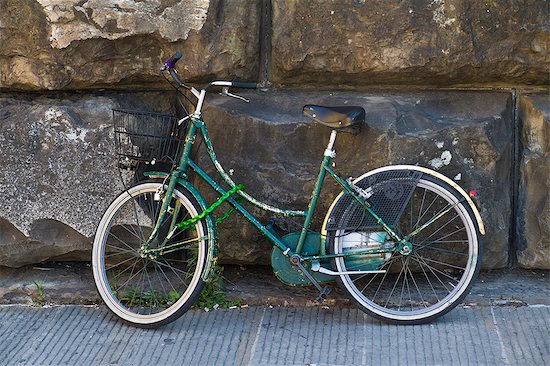 Italy, Florence, Old green bike against stone wall Stock Photo - Premium Royalty-Free, Image code: 640-06050207