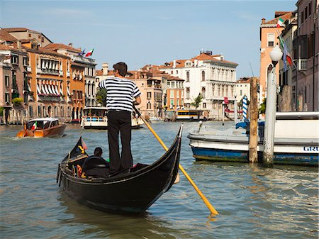 Italy, Venice, Young woman traveling in gondola on canal Stock Photo - Premium Royalty-Free, Code: 640-06050230