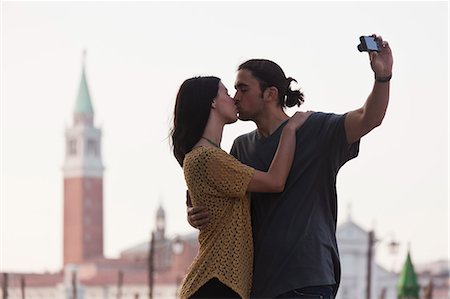 simsearch:640-06050244,k - Italy, Venice, Young couple kissing and photographing self, San Giorgio Maggiore church in background Stock Photo - Premium Royalty-Free, Code: 640-06050271