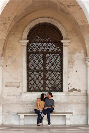 Italy, Venice, Young couple sitting on old bench Stock Photo - Premium Royalty-Free, Code: 640-06050273