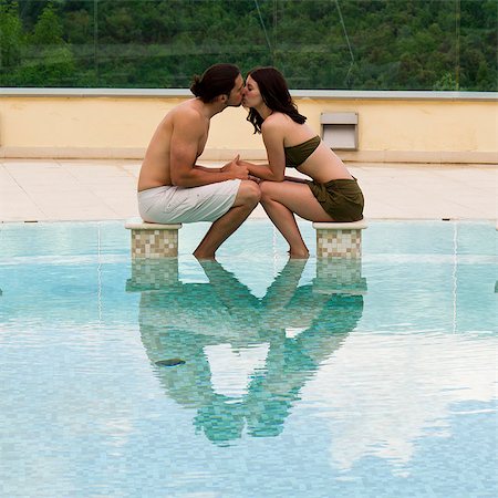 Italy, Tuscany, Young couple kissing in pool Stock Photo - Premium Royalty-Free, Code: 640-06050304