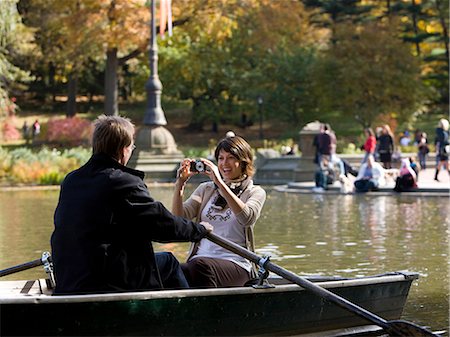 person sitting in pond - USA, New York City, Manhattan, Central Park, Mature woman photographing man in boat in Central Park Stock Photo - Premium Royalty-Free, Code: 640-06050690