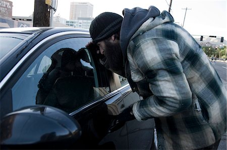 person peeking in car - USA, Utah, Salt Lake City, Homeless man peering into car, side view Stock Photo - Premium Royalty-Free, Code: 640-06050720