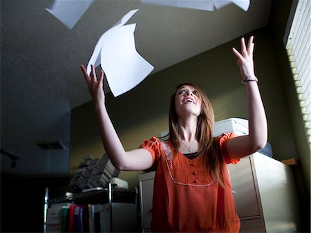 USA, Utah, Orem, Young woman throwing up documents Stock Photo - Premium Royalty-Free, Code: 640-06050761