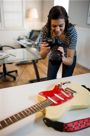 people holding camera slr - USA, Utah, Orem, Teenage girl (16-17) photographing guitar Stock Photo - Premium Royalty-Free, Code: 640-06050804