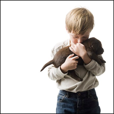 puppy with child white background - child with puppy Stock Photo - Premium Royalty-Free, Code: 640-06050844