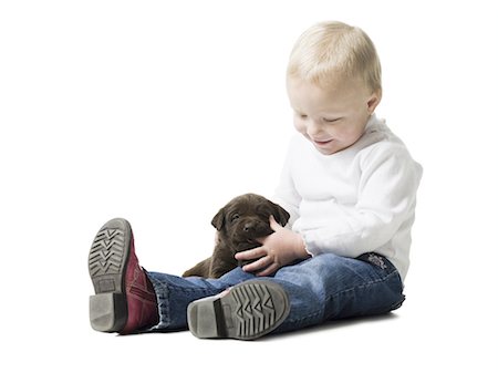 puppy with child white background - child with puppy Stock Photo - Premium Royalty-Free, Code: 640-06050848