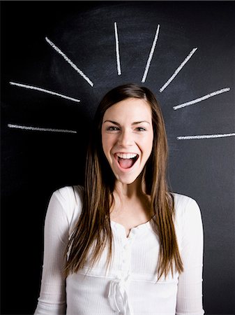 young woman against a chalkboard Stock Photo - Premium Royalty-Free, Code: 640-06051057