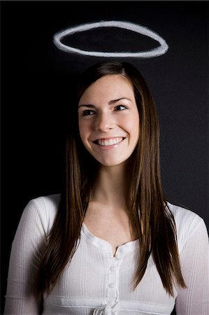 young woman against a chalkboard Stock Photo - Premium Royalty-Free, Code: 640-06051052