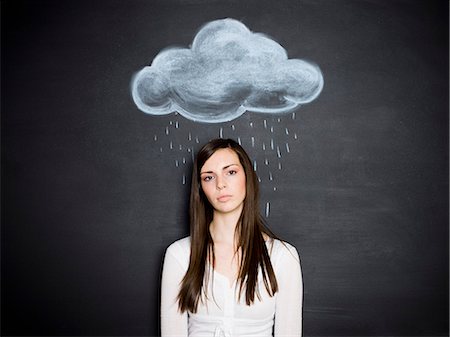 young woman against a chalkboard Stock Photo - Premium Royalty-Free, Code: 640-06051074