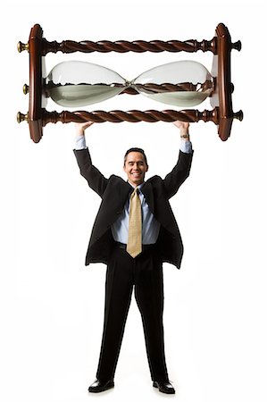 businessperson holding up an hourglass Stock Photo - Premium Royalty-Free, Code: 640-06051190