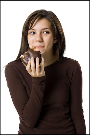 doughnut diet - young woman eating junk food Stock Photo - Premium Royalty-Free, Code: 640-06051390