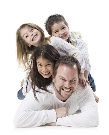 father and three children lying on top of each other Stock Photo - Premium Royalty-Free, Code: 640-06051604