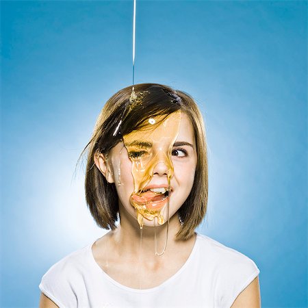 prank - girl with honey pouring on her head Stock Photo - Premium Royalty-Free, Code: 640-06051675