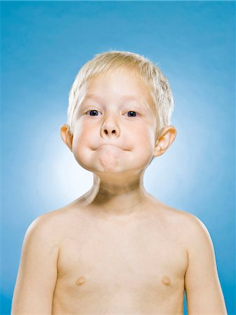 scared boy - boy against a blue background Stock Photo - Premium Royalty-Free, Code: 640-06051680