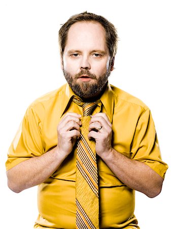 raddrizzare - man in a yellow shirt and tie fixing his tie Fotografie stock - Premium Royalty-Free, Codice: 640-06051699