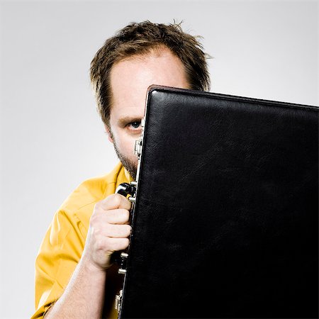 simsearch:640-06051719,k - man hiding behind his briefcase Stock Photo - Premium Royalty-Free, Code: 640-06051701