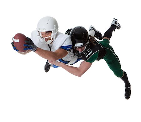 Two male players of American football fighting for ball, studio shot Stock Photo - Premium Royalty-Free, Code: 640-06963164