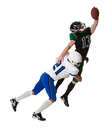 Two male players of American football fighting for ball, studio shot Photographie de stock - Premium Libres de Droits, Code: 640-06963160