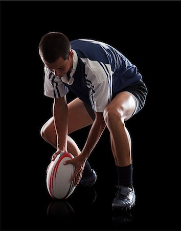 rugby - Studio portrait of teenage boy (14-15) with rugby ball Photographie de stock - Premium Libres de Droits, Code: 640-06963234