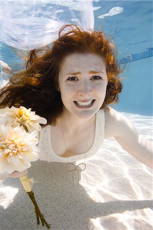 USA, Utah, Orem, Portrait of young bride with bouquet under water Stock Photo - Premium Royalty-Free, Code: 640-06963263