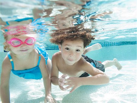 day time underwater - USA, Utah, Orem, Boy (4-5) and girl (2-3) swimming in pool Stock Photo - Premium Royalty-Free, Code: 640-06963368