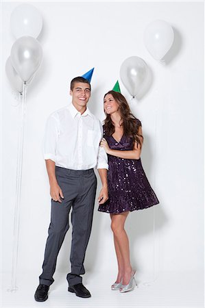 smart couple intelligent - Young couple smiling among balloons at party Stock Photo - Premium Royalty-Free, Code: 640-06963494