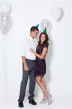 Young couple embracing at party Foto de stock - Sin royalties Premium, Código: 640-06963493