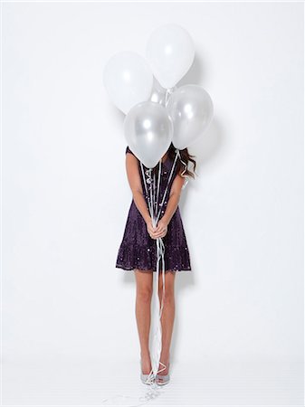 simsearch:640-06963479,k - Young woman hiding behind balloons at party Stock Photo - Premium Royalty-Free, Code: 640-06963505