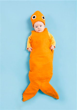 funny baby photo - Portrait of baby boy (2-5 months) in goldfish costume Stock Photo - Premium Royalty-Free, Code: 640-06963546